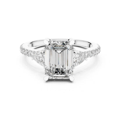 Diamond ring with a central emerald-cut moissanite  diamond and smaller diamonds on a white background