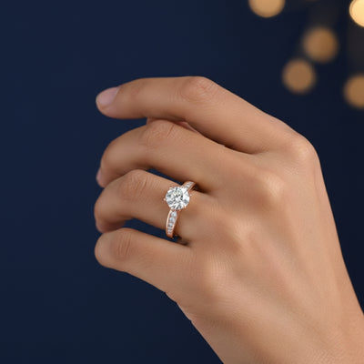 Hand wearing a 1ct Moissanite diamond ring with a dark background