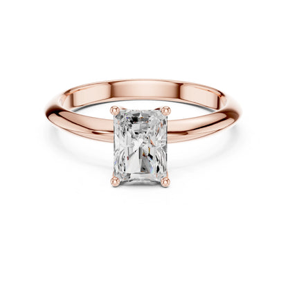 Rose gold ring with a rectangular moissanite diamond on a white background