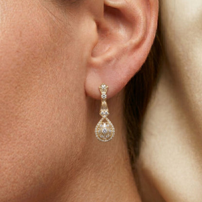 Close-up of a moissanite diamond earring on an ear with a soft focus background