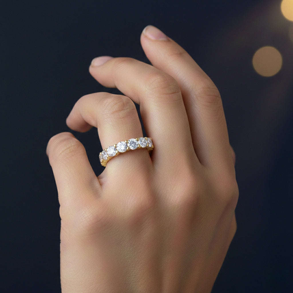Hand wearing a Moissanite diamond ring with a dark background