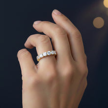Load image into Gallery viewer, Hand wearing a Moissanite diamond ring with a dark background