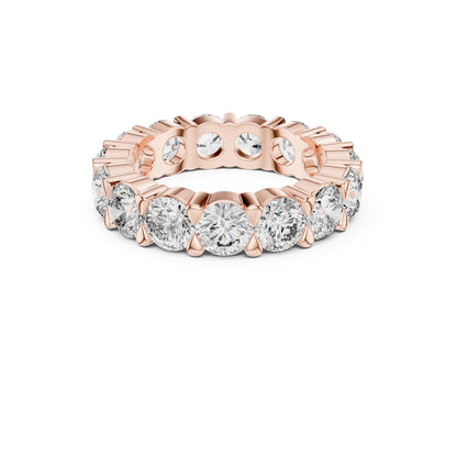 Rose gold ring with Moissanite diamonds on a white background