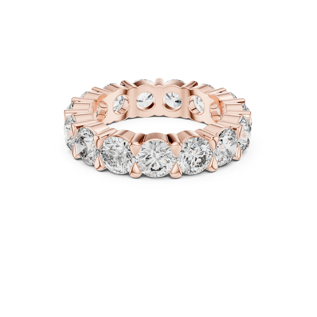 Rose gold ring with Moissanite diamonds on a white background