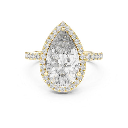 Gold ring with a large pear-shaped moissanite diamond and smaller diamonds on a white background