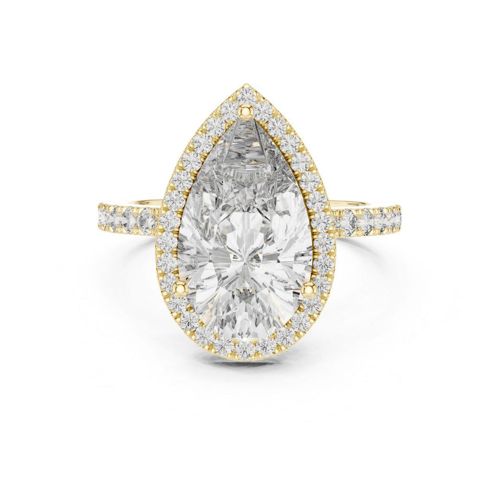 Gold ring with a large pear-shaped moissanite diamond and smaller diamonds on a white background