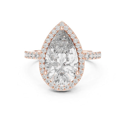 Rose gold ring with a pear-shaped moissanite diamond on a white background