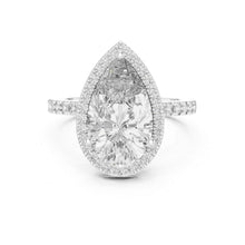 Load image into Gallery viewer, Teardrop-shaped moissanite diamond ring with a halo of smaller diamonds on a white background