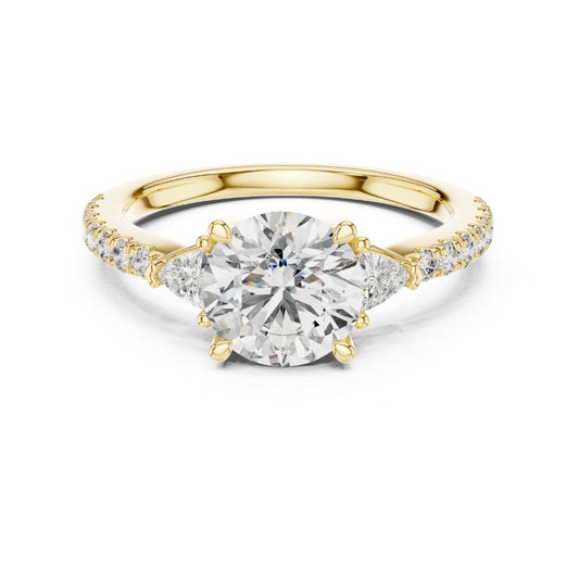 Gold ring with a large moissanite diamond and smaller diamonds on the band against a white background