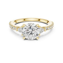 Load image into Gallery viewer, Gold ring with a large moissanite diamond and smaller diamonds on the band against a white background