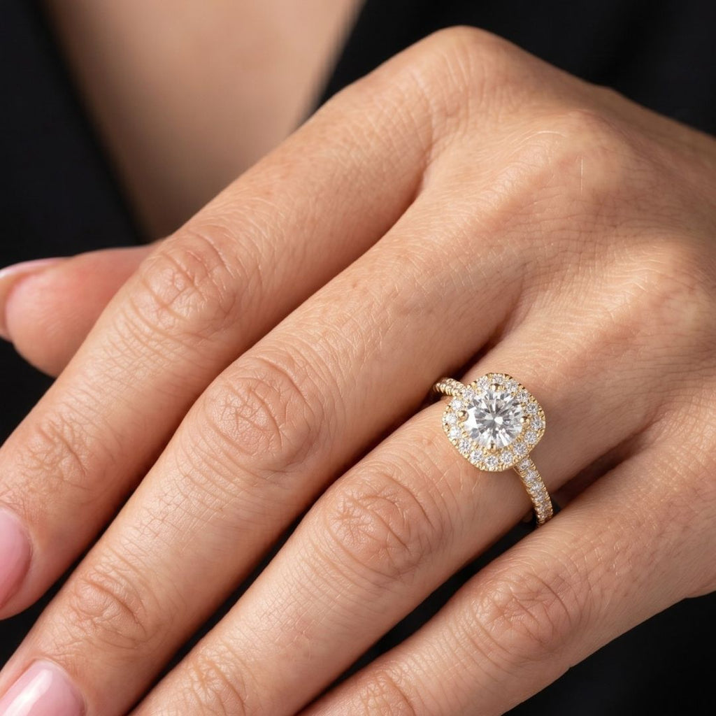Close-up of a hand wearing a moissanite  diamond ring with a dark background
