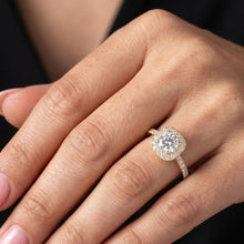 Load image into Gallery viewer, Close-up of a hand wearing a moissanite  diamond ring with a dark background