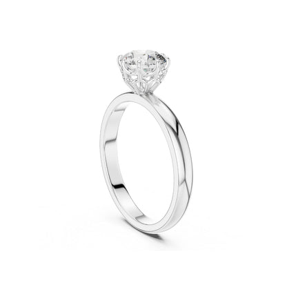 Silver ring with a 1ct moissanite round diamond on a white background